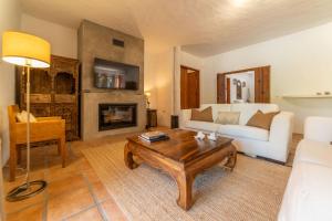 a living room with a couch and a coffee table at Villa Bambu in Charneca