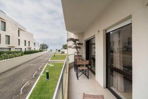 a balcony with a table on the side of a building at Oceanfront Views & Modern Elegance by HostWise in Vila do Conde