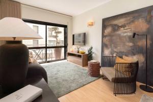 a living room with a couch and a chair at Oceanfront Views & Modern Elegance by HostWise in Vila do Conde