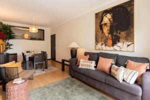 a living room with a couch and a dining room at Oceanfront Views & Modern Elegance by HostWise in Vila do Conde +50 photos