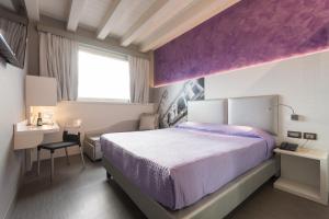 Postel nebo postele na pokoji v ubytování Hotel Doge