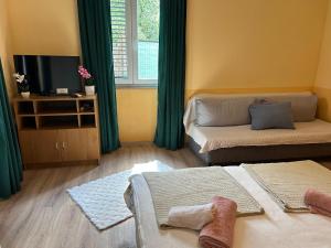 a living room with two beds and a couch at Apartment Bačvice in Split