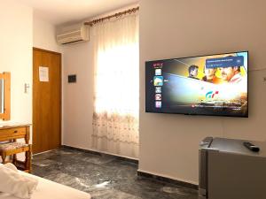 a room with a flat screen tv on a wall at Lenitsa Central Parga Rooms in Parga