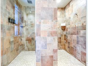 a bathroom with a shower with a glass door at Maison Des Jardins B & B in Montreal +171 photos