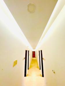 a hallway in a building with a white ceiling at FabHotel Elvin's Place in Calangute