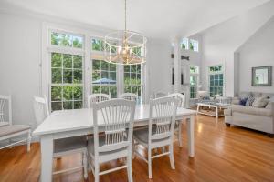 a white dining room with a white table and chairs at Captain's Row: Pool, Tennis Chatham Charm in Chatham