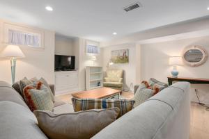 a living room with a couch and a table at Captain's Row: Pool, Tennis Chatham Charm in Chatham