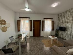 a living room with a couch and a glass table at Fina beach in Nules
