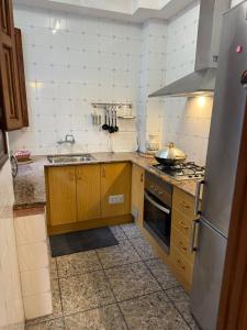 a kitchen with a sink and a stove at Fina beach in Nules