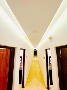 a corridor in a building with a long hallway at FabHotel Elvin's Place in Calangute +13 photos