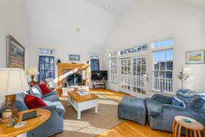 a living room with blue couches and a table at Lake front, Near Beach, AC, WiFi, Pet Friendly near Bike Path in Chatham