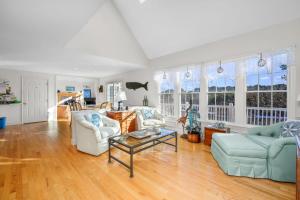 a living room with two couches and a table at Lake front, Near Beach, AC, WiFi, Pet Friendly near Bike Path in Chatham