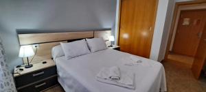 a hotel room with a bed with towels on it at Enebrales 304 in Punta Umbría +29 photos