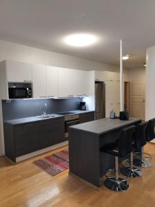 a kitchen with a large island in the middle at Varakoti Helmi in Loimaa