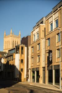 an empty street in front of a brick building at Wilde Cambridge City Centre in Cambridge