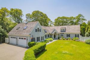 a house with a garage and a yard at Bay Breeze Escape—Pool, Game Room Views in Centerville