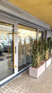 a front door of a store with potted plants at Vilnius Luxurious flat in Vilnius