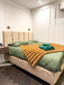 a bedroom with a bed with a blanket on it at Vilnius Luxurious flat in Vilnius