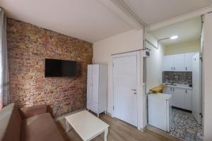 a living room with a couch and a brick wall at Angela Inn Boutique in Istanbul