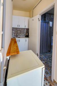 a small kitchen with white cabinets and a table at Angela Inn Boutique in Istanbul +5 photos