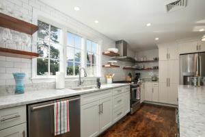 a kitchen with white cabinets and a large window at Newly updated home sleeps 7, AC, free WIFI, half mile to town in Chatham