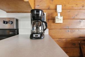 a black coffee pot sitting on a counter top at Chalet #18 in Stevensville +34 photos