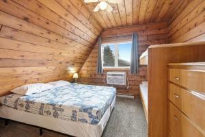 a bedroom with a bed in a wooden cabin at Chalet #18 in Stevensville