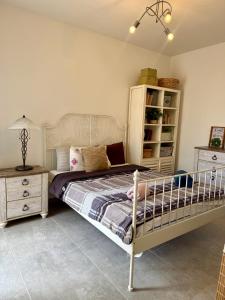 a bedroom with a bed and a dresser at Azure Dome Residences in Għajnsielem