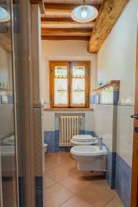 a bathroom with a toilet and a sink at Poggio del Raglio in Trequanda +32 photos