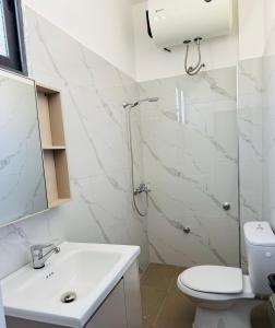 a bathroom with a toilet and a sink and a shower at Villa JURGEN in Durrës +35 photos