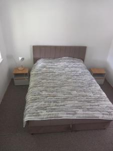 a bed in a room with two nightstands and a bed sidx sidx sidx at Apartman Cicović in Foča