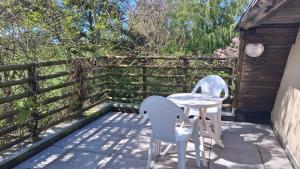 two chairs and a table on a patio at Chambre d' hôtes Etigue - Etretat in Les Loges +4 photos