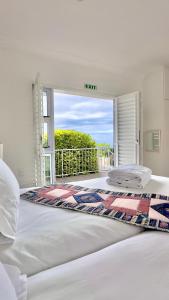 a bedroom with a large bed with a large window at Somerset View Guest House in Somerset West +160 photos
