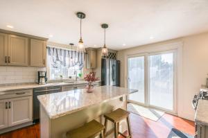 a kitchen with a large island with two bar stools at Cape Cod Home—Deck, Near Canal Bike Path in Sandwich