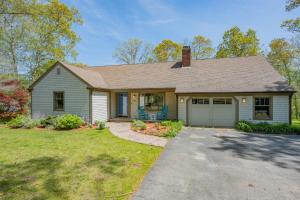 a house with a garage in a yard at Gorgeous Cape Cod Retreat Near Town Neck in East Sandwich