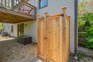 a wooden gate in front of a house at Gorgeous Cape Cod Retreat Near Town Neck in East Sandwich