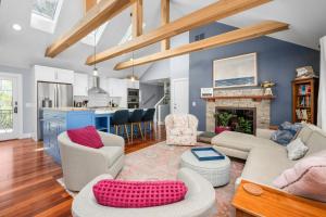 a living room with couches and a fireplace at Gorgeous Cape Cod Retreat Near Town Neck in East Sandwich +30 photos