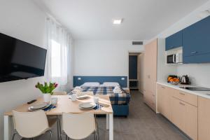 a bedroom with a bed and a table and chairs at FEEL - Palazzo Ortelli in Bergamo