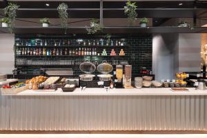 a counter with some food on top of it at B&B HOTEL Basel in Basel