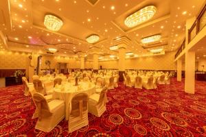 a banquet hall with white tables and white chairs at Owinmo Hotel & reception Hall in Galle +58 photos