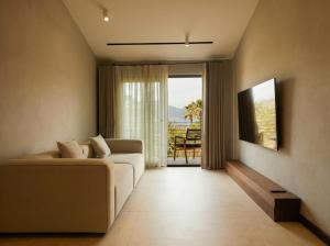 a living room with a couch and a large window at Selimiye Sardunya Hotel & Restaurant in Marmaris
