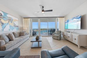 a living room with a couch and a tv at Bella Luna 908 in Orange Beach
