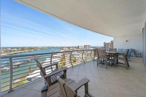 a balcony with a table and chairs and the ocean at Bella Luna 908 in Orange Beach