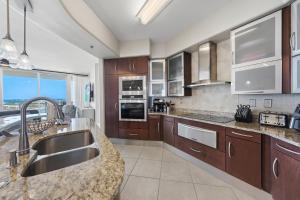 a kitchen with a sink and a counter top at Bella Luna 908 in Orange Beach +45 photos