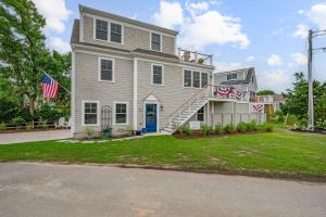 a large white house with a blue door at Happy As A Clam in Chatham +33 photos