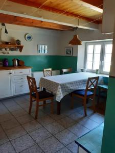 a kitchen with a table and chairs in a room at Ferienhaus Petersen in Langeneß