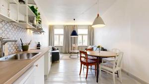 a kitchen and dining room with a table and chairs at tARTu Stays 5-3 Spacious Apartment Tartu Old Town in Tartu