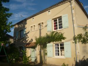 an old house with green shutters on it at Le Couvent in Lagardelle