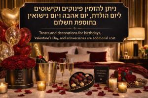 a room with a bed with a table with glasses of champagne at R suite in Netanya