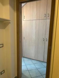 a kitchen with white cabinets and a tile floor at La Casetta in Lacco Ameno